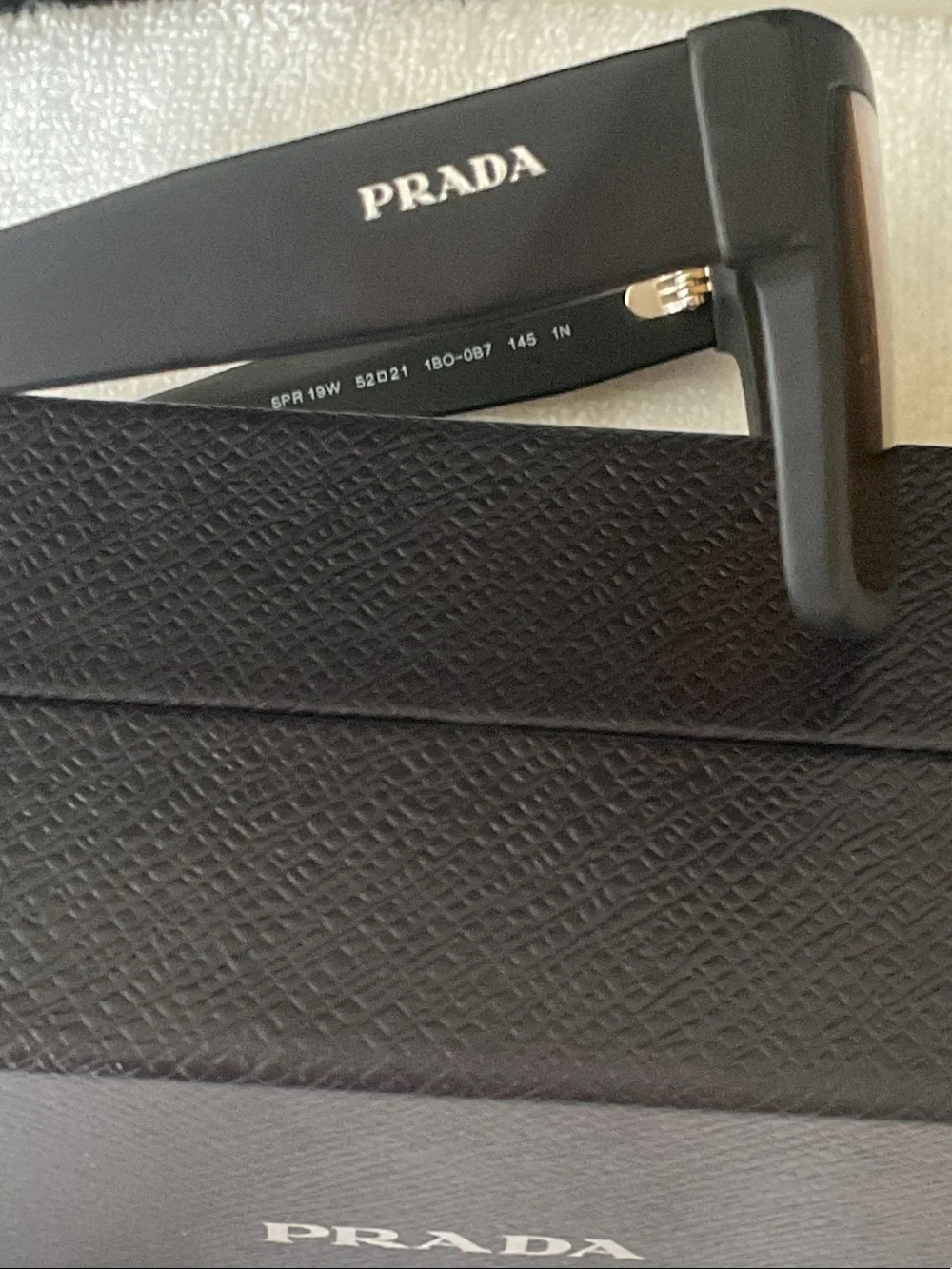 Prada Matte Black Rectangular Sunglasses with Amber Lenses